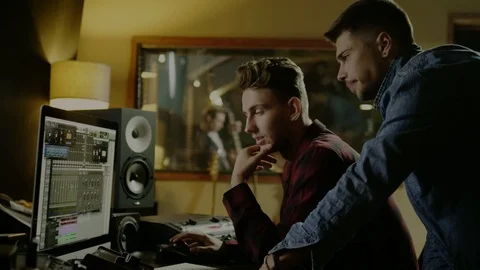 Sound engineers working in garage recording studio Stock Footage 101461617