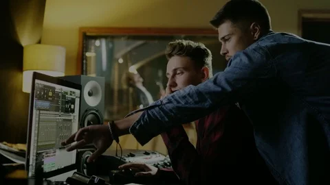 Sound engineers working in garage recording studio Stock Footage 101461648