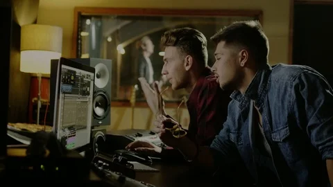 Sound engineers working in garage recording studio Stock Footage 101461708