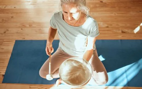 Sound healing, bowl and senior yoga woman practice alternative medicine for aura Stock Photos
