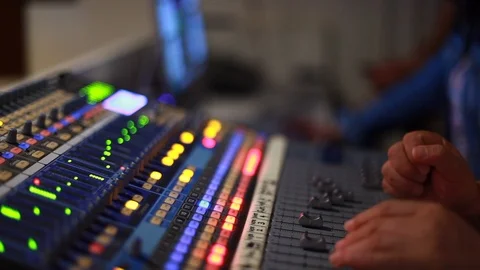 Sound Man Using Sound Desk in Sound Booth with Other People (Racking Focus) Stock Footage