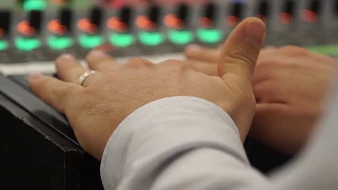 Sound Tech Sets Levels on Mixer to Record Audio Stock Footage 81934554