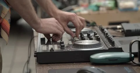 Sound technician hands operating analog audio mixer at live event Stock Footage 346731974