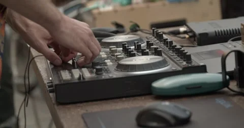 Sound technician hands operating analog audio mixer at live event Stock Footage 346731987