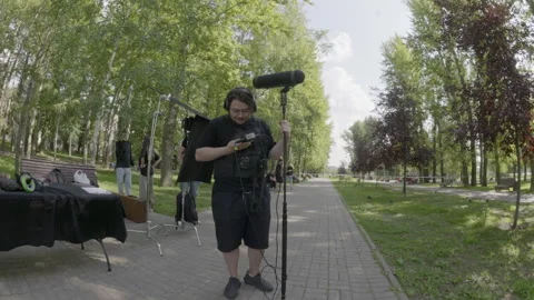 Sound technician sets audio stuff preparing to film shooting Stock Footage 308933997