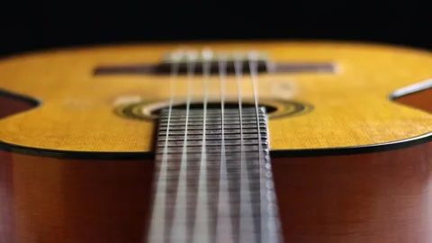 The Sound of Tradition: A Close-Up Look at the Strings of a Classical Guitar Stock Footage 231337571