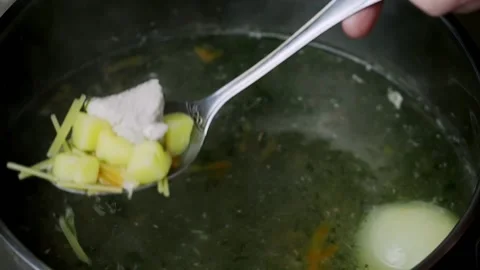 Soup boiling in the pot stirred with a spoon. Stock Footage 170058348
