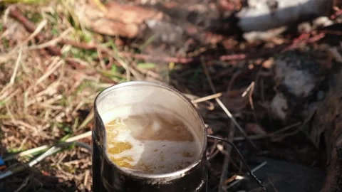 Soup boils in a camp pot in the open air, and steam rises over it. Slow motion. Stock Footage 168091496