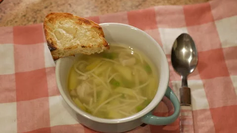 Soup in a bowl on a checkered tablecloth Stock Footage 152833240