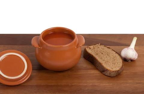 Soup in ceramic pot with bread and garlic Stock Photos