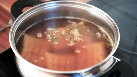 Soup cooks in a pot on the stove Stock Footage 120954529