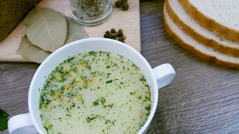 Soup decorated with fresh vegetables and bread. Stock Footage 83796229
