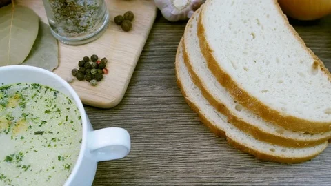 Soup decorated with fresh vegetables and bread. Stock Footage 84065206
