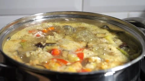 Soup with meatballs is being cooked. The dish is boiling with bubbles in th.. Stock Footage 325790744