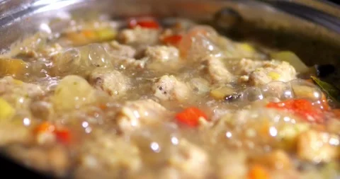 Soup with meatballs is being cooked. The dish is boiling with bubbles in th.. Stock Footage 325791096