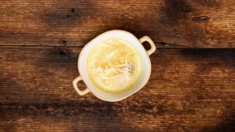The soup is poured into a plate. Stop motion. Chicken soup with spaghetti and Stock Footage 168314384
