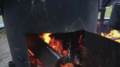 Soup is ready in a cauldron in nature. The camera moves from bottom to top Video stock 169786252