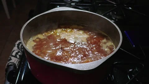 Soup Simmering in a Red Pot on a Kitchen Stove at Nigh Stock Footage 319208274