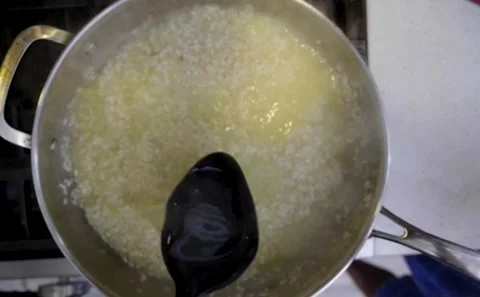 Soup Spoon Adding Stock To Boiling Risotto Rice Slowmo Stock Footage 139232983