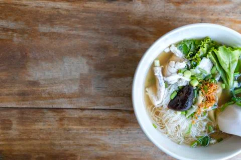 Soup with thin noodle, pock, pock stick, mushroom, vegetable in white bowl on Stock Photos