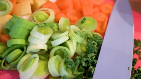 Soup vegetables cut into small pieces on a cutting board 2 Stock Footage 124679744