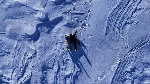 Сouple lying in the snow. Aerial view of Gudauri ski resort in winter. Stock Footage 315735731
