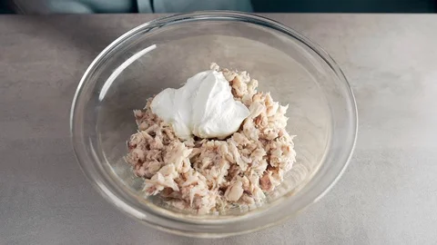 Sour creme falls down from the spoon into the meal in slow motion, chef makes Stock Footage 72980313