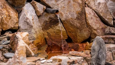 The source of bubbles of mineral water seltzer in the well with red walls Stock-Footage 69267599