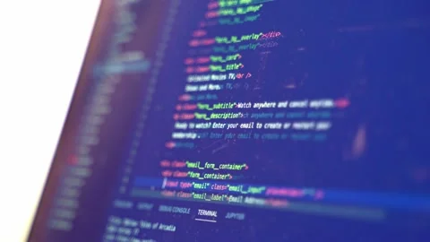 Source code for a new website is scrolled by while a computer hacker looks Stock Footage 211937864