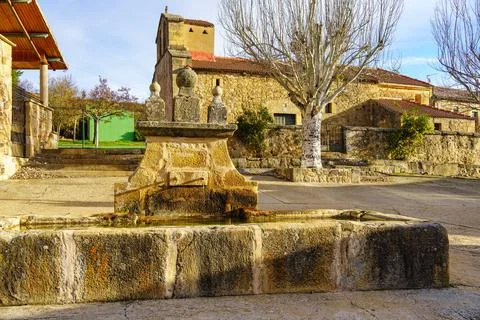 Source of fresh mountain water in the square of the old stone village, Spain. Stock Photos