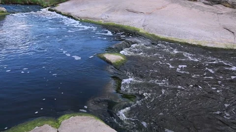 Source of a mountain river, seething water flowing over stone blocks. Stock Footage 169938489