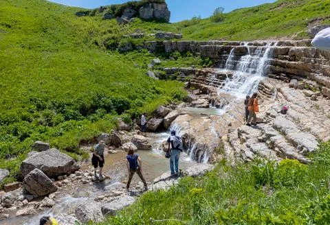The source of a mountain river, on the slopes and in a stone riverbed in the Stock Photos