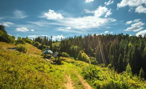 Source with spring water and an arbor on a hill slope Stock Photos