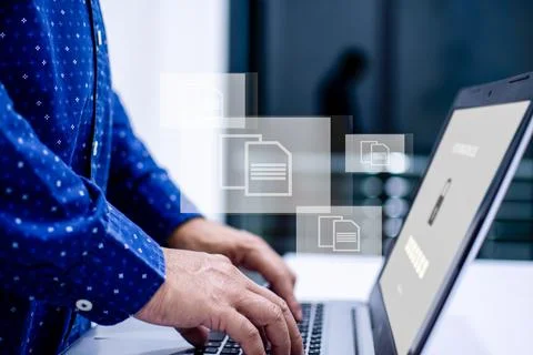 .Source text.Men standing and typing a document with a notebook computer on.. Stock Photos