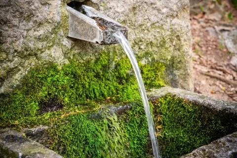 Source of underground clean ionized and ozone water in the mountains of Stock Photos