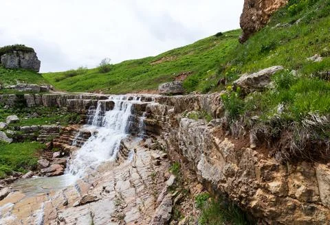 The sources of a mountain river high in the mountains on alpine meadows durin Stock Photos