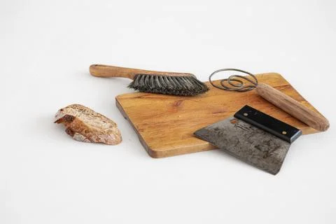 Sourdough bread and baking tools on bread board Stock Photos