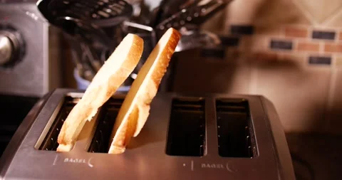 Sourdough bread being place into toaster four slices Stock Footage 150606955