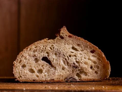 Sourdough Bread Slice Cross Section Showing Airy Crumb Texture on Wooden Boar Stock Photos