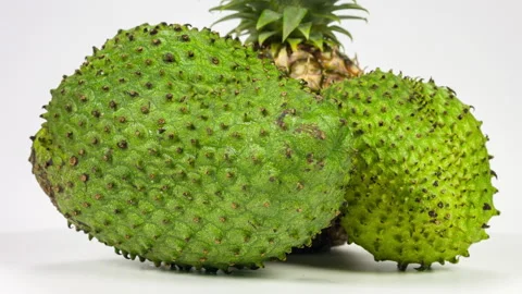 Soursop, Graviola, Guyabano and pineapple isolate rotation on white background Stock Footage 89737896