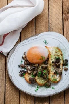 Sous vide egg with bread and wild mushrooms, copy space Stock Photos