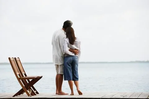 South American couple hugging on dock Stock Photos