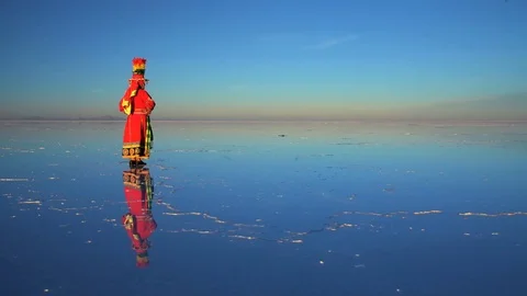 South American Indigenous female standing in traditional dress at sunset on the Stock Footage