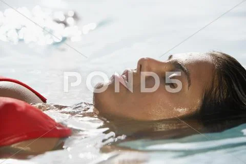 South American Woman Floating In Water
