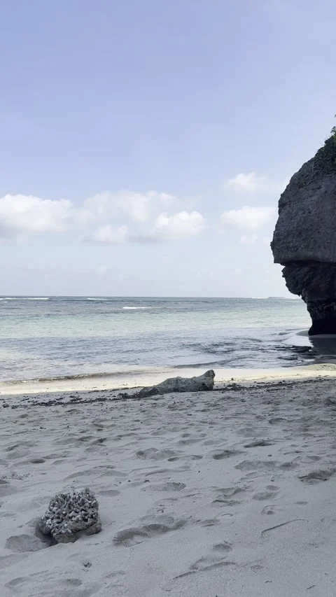 South Bali Beach with Dramatic Rock Formation Vertical Tropical Background Stock Footage 328528878