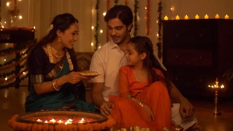 South Indian family dressed in traditional wear is celebrating Diwali at home Stock Footage
