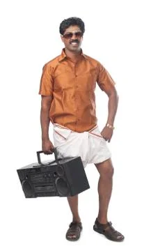South Indian man listening to a music system Stock Photos
