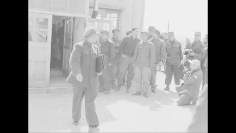 SOUTH KOREA - 1953: Processing line - Men queue beside a building and fence Video stock 344499562