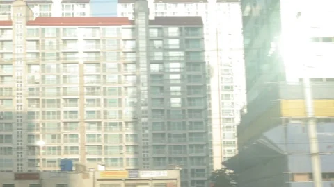 South Korea view from moving train of highrise buildings and suburbs Stock Footage 100595164