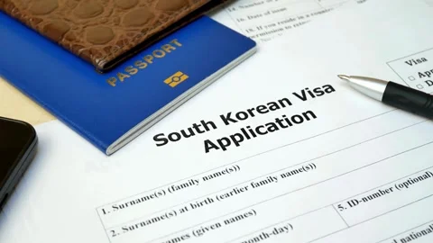South Korean visa application form with blue passport and smartphone Stock Footage 332727822